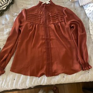 Shop Stevie rust colored top with keyhole opening in back. Worn once.